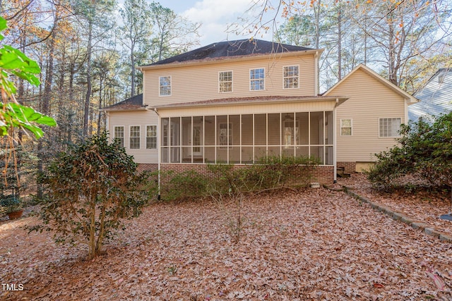 rear view of house featuring a sunroom