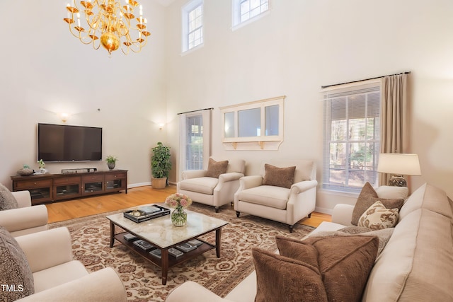 living room featuring a healthy amount of sunlight, hardwood / wood-style floors, and a high ceiling