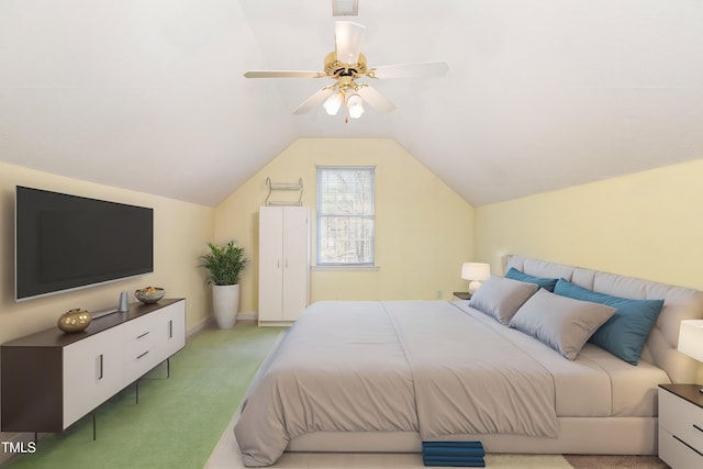 bedroom featuring lofted ceiling, light colored carpet, and ceiling fan