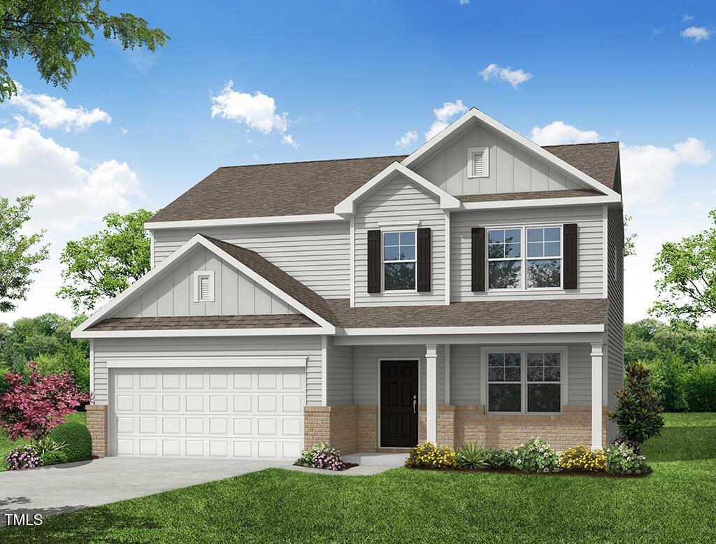 craftsman house featuring a front yard and a garage