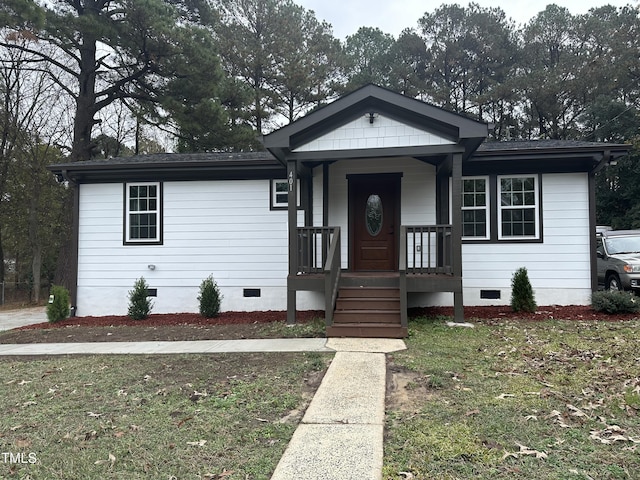 bungalow-style home featuring a front lawn