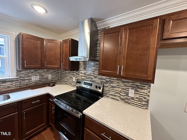 kitchen with wall chimney exhaust hood, crown molding, tasteful backsplash, stainless steel electric range, and light stone countertops