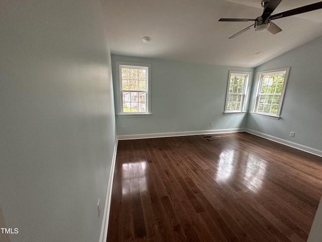 unfurnished room featuring dark wood-type flooring, a healthy amount of sunlight, lofted ceiling, and ceiling fan