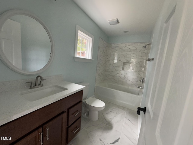 full bathroom with vanity, tiled shower / bath combo, and toilet