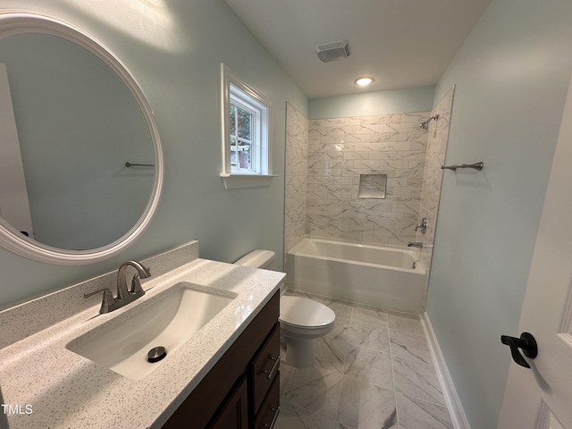 full bathroom with tiled shower / bath, vanity, and toilet