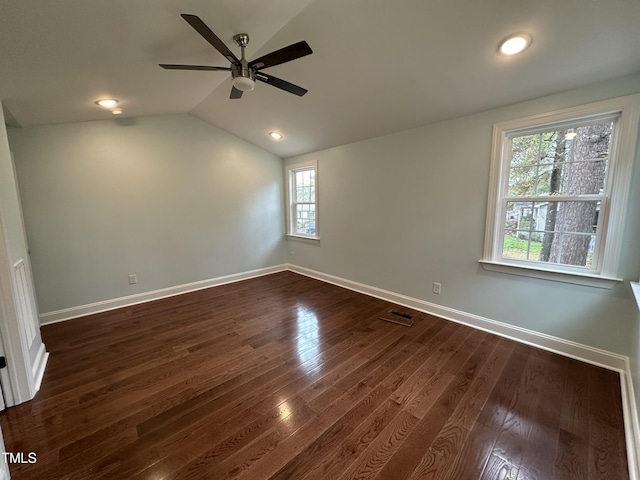 spare room featuring lofted ceiling, dark hardwood / wood-style floors, and ceiling fan