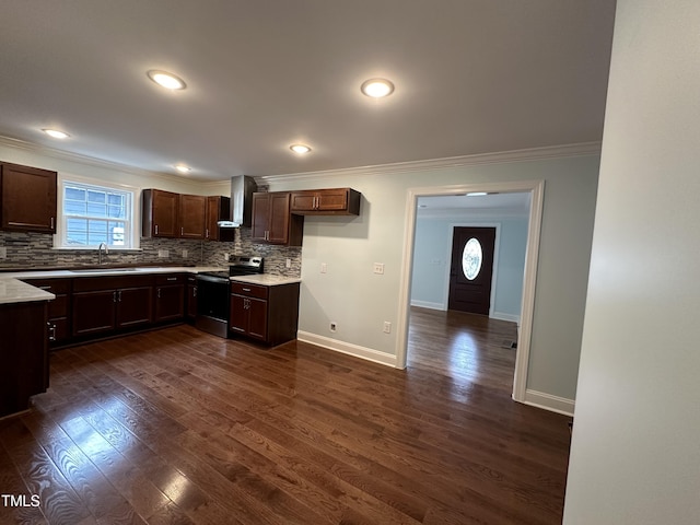 kitchen with sink, crown molding, stainless steel range with electric stovetop, wall chimney range hood, and backsplash