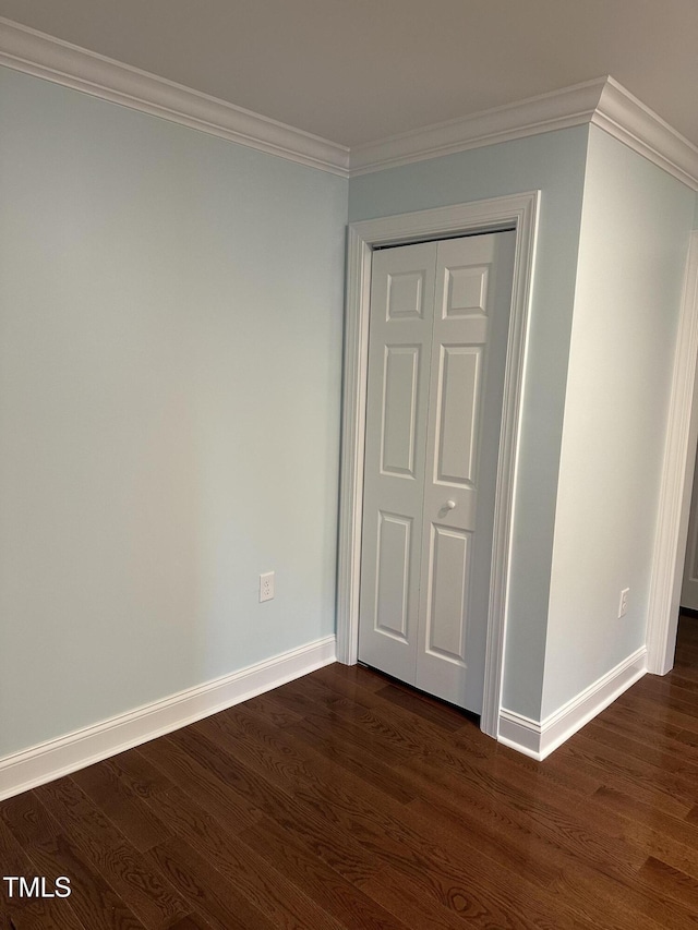 interior space with crown molding, dark hardwood / wood-style floors, and a closet