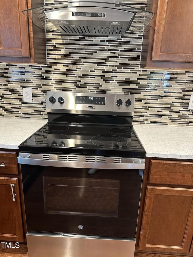 kitchen featuring tasteful backsplash, extractor fan, and electric stove