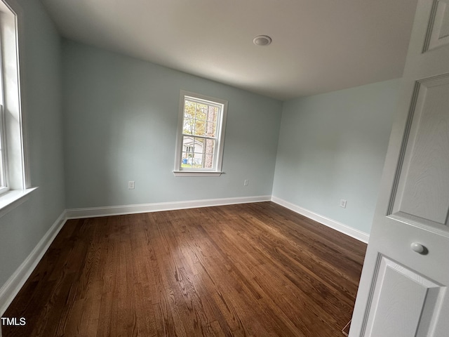 empty room featuring dark hardwood / wood-style flooring