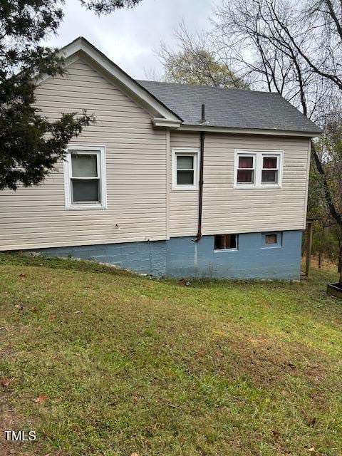 view of side of property with a yard