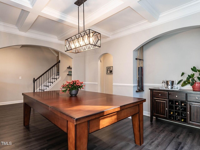 dining area with dark hardwood / wood-style floors, beam ceiling, ornamental molding, and coffered ceiling