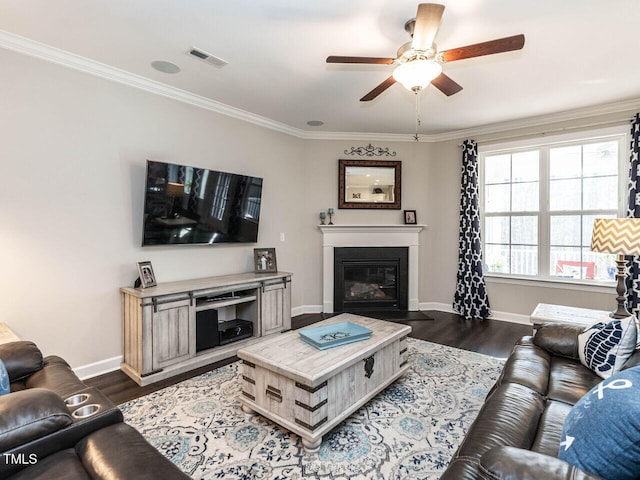 living room featuring ceiling fan, dark hardwood / wood-style flooring, and ornamental molding