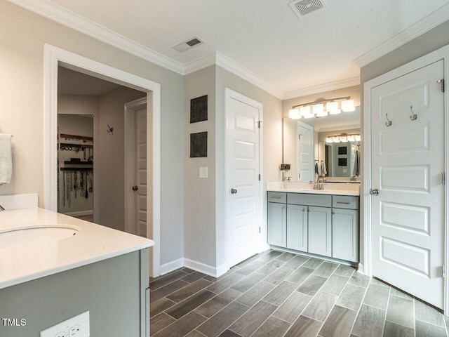 bathroom featuring vanity and ornamental molding