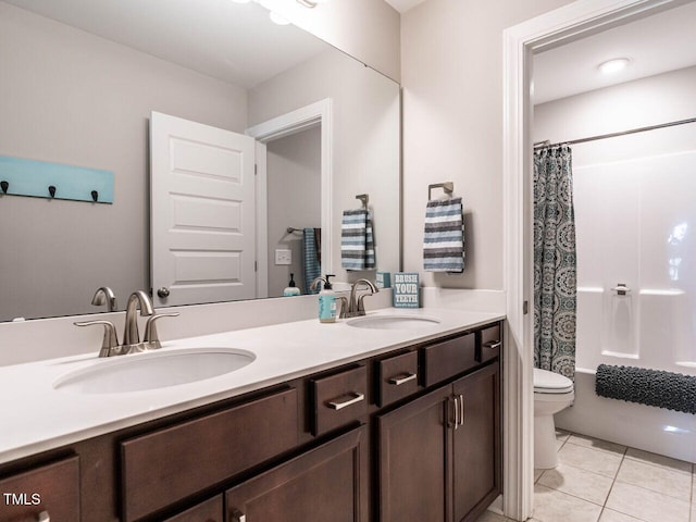 full bathroom featuring tile patterned flooring, shower / bath combination with curtain, vanity, and toilet