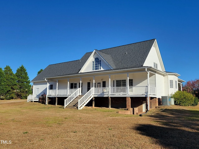 back of property featuring a porch, a yard, and cooling unit