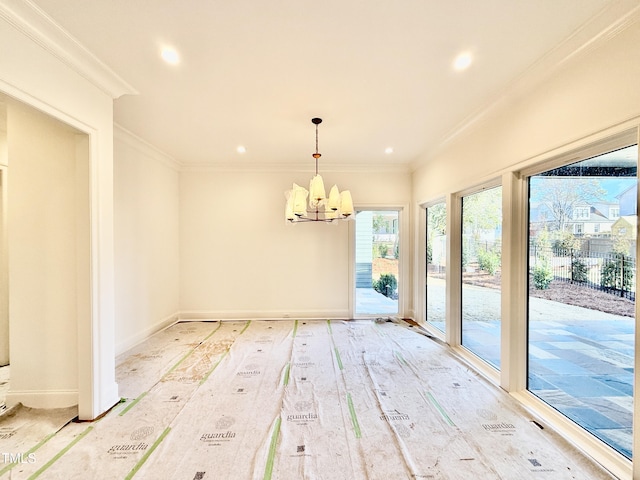 unfurnished dining area featuring ornamental molding, a chandelier, and wood-type flooring