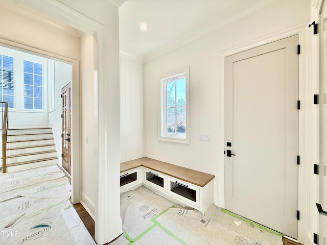 mudroom with light hardwood / wood-style flooring and crown molding