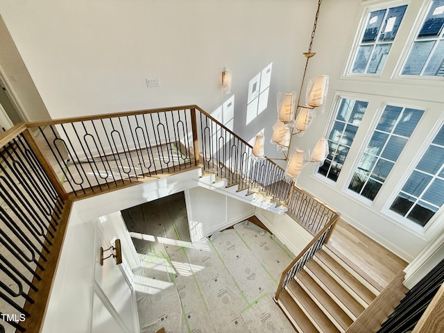 staircase featuring a towering ceiling