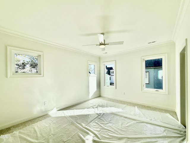 unfurnished bedroom featuring ceiling fan, ornamental molding, and light carpet