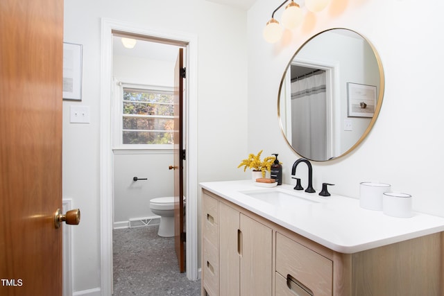 bathroom with vanity and toilet