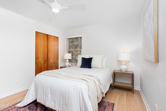 bedroom featuring a closet, light hardwood / wood-style flooring, and ceiling fan