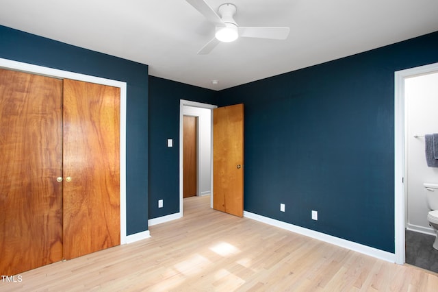 unfurnished bedroom with ceiling fan, light hardwood / wood-style flooring, connected bathroom, and a closet