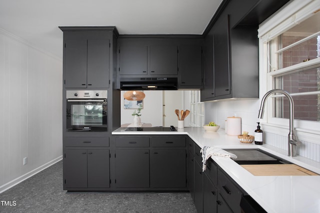 kitchen featuring stainless steel oven, exhaust hood, sink, ornamental molding, and black cooktop