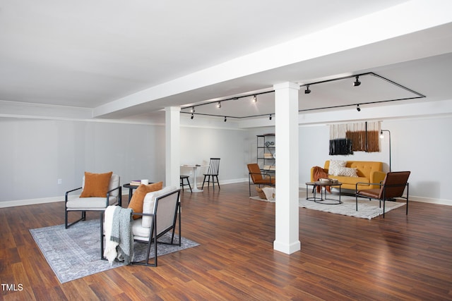 sitting room with dark hardwood / wood-style floors and track lighting