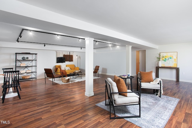 sitting room with dark hardwood / wood-style floors and rail lighting