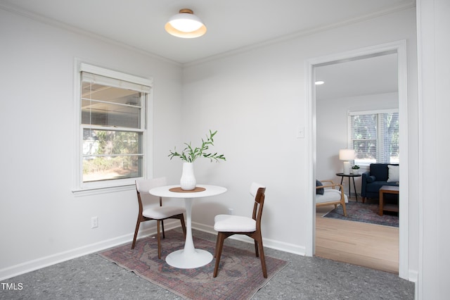 dining space featuring hardwood / wood-style flooring, plenty of natural light, and crown molding