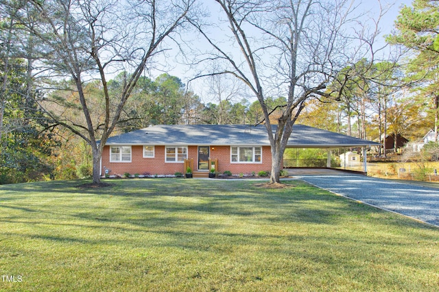 ranch-style home with a front yard and a carport