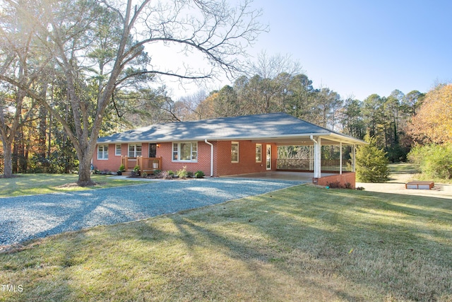 ranch-style house with a front yard and a carport