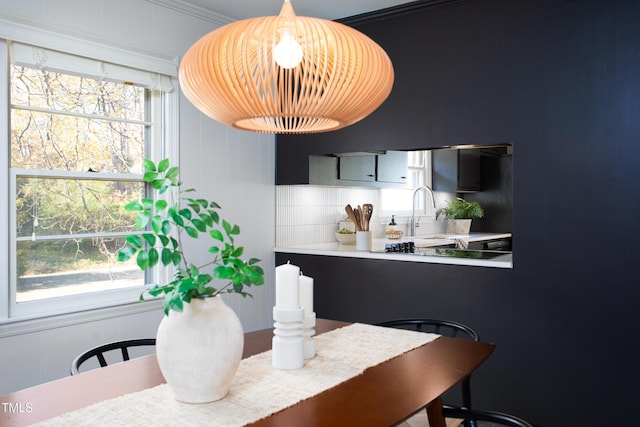 dining area with ornamental molding and sink