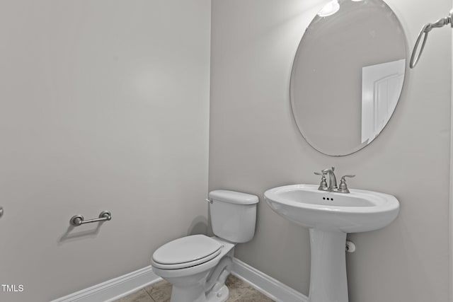 bathroom with tile patterned flooring and toilet