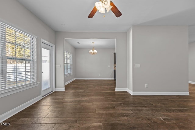 unfurnished room featuring dark hardwood / wood-style floors and ceiling fan with notable chandelier