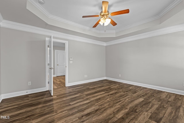 spare room with dark hardwood / wood-style floors, ceiling fan, and ornamental molding