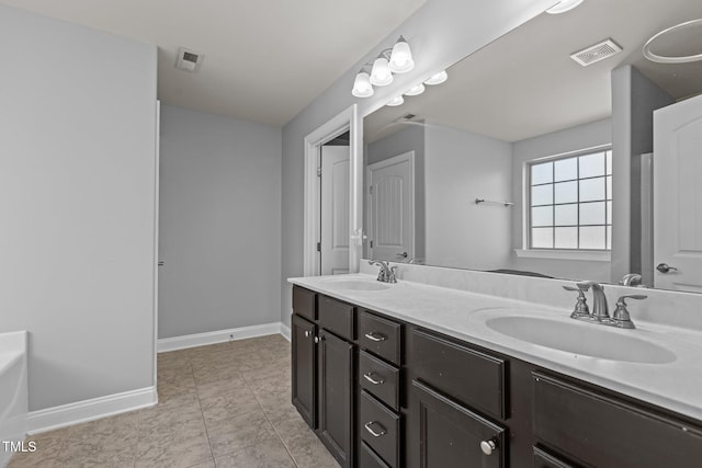 bathroom with tile patterned floors and vanity