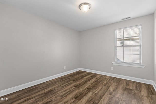 unfurnished room with dark hardwood / wood-style floors