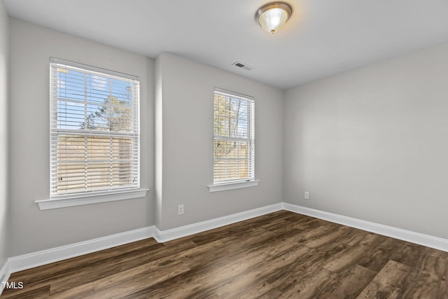 unfurnished room featuring dark hardwood / wood-style floors