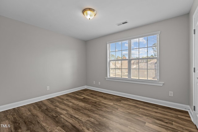 unfurnished room featuring dark hardwood / wood-style floors