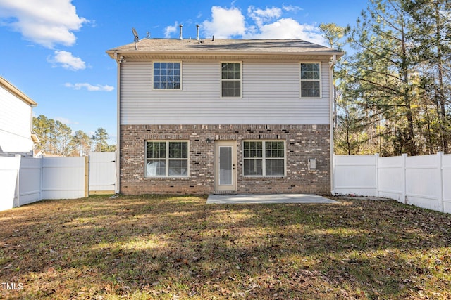 view of front of home featuring a front lawn and a patio