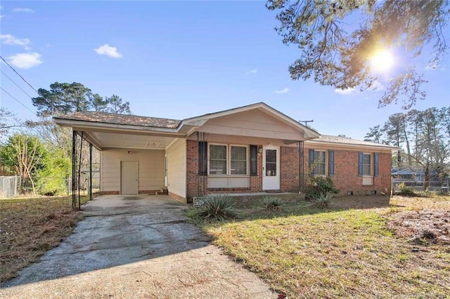 ranch-style house with a carport and a front lawn