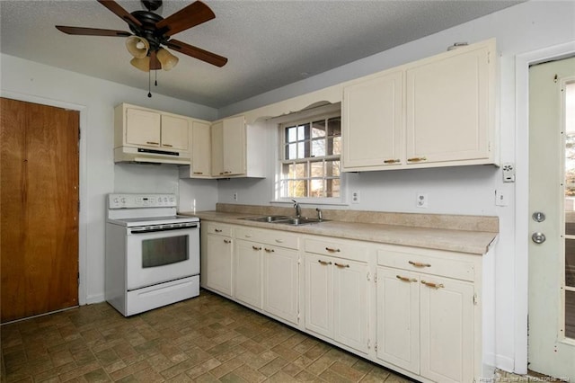 kitchen with electric range, sink, ceiling fan, and a textured ceiling