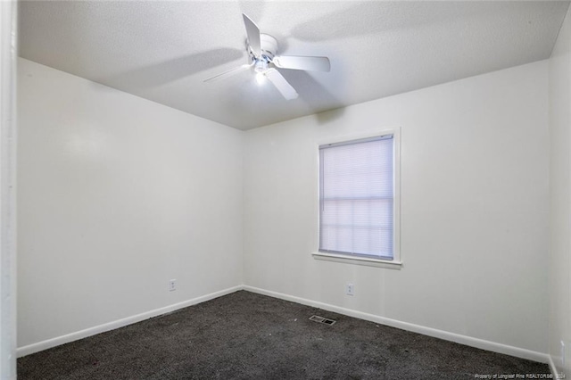 carpeted empty room with ceiling fan and a textured ceiling