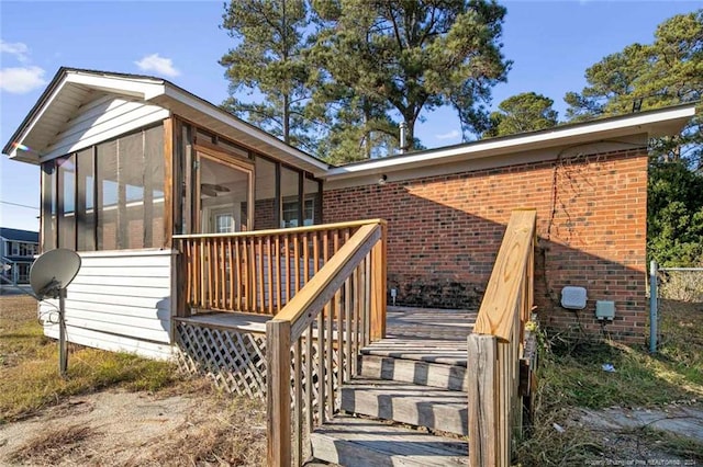 view of property exterior with a deck and a sunroom