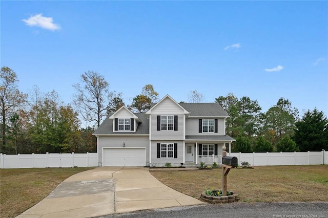 view of front of house with covered porch, a garage, and a front lawn