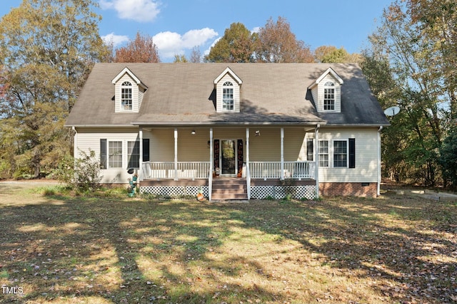 cape cod home featuring a porch and a front lawn