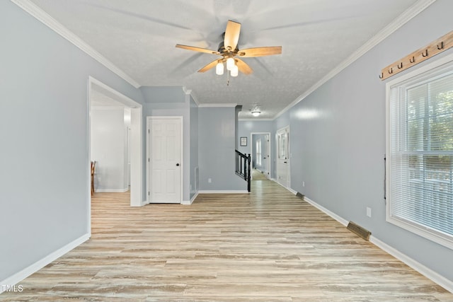 unfurnished room with a textured ceiling, light hardwood / wood-style floors, ceiling fan, and ornamental molding