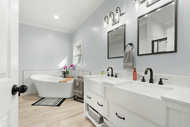 bathroom featuring plus walk in shower, wood-type flooring, vanity, and crown molding